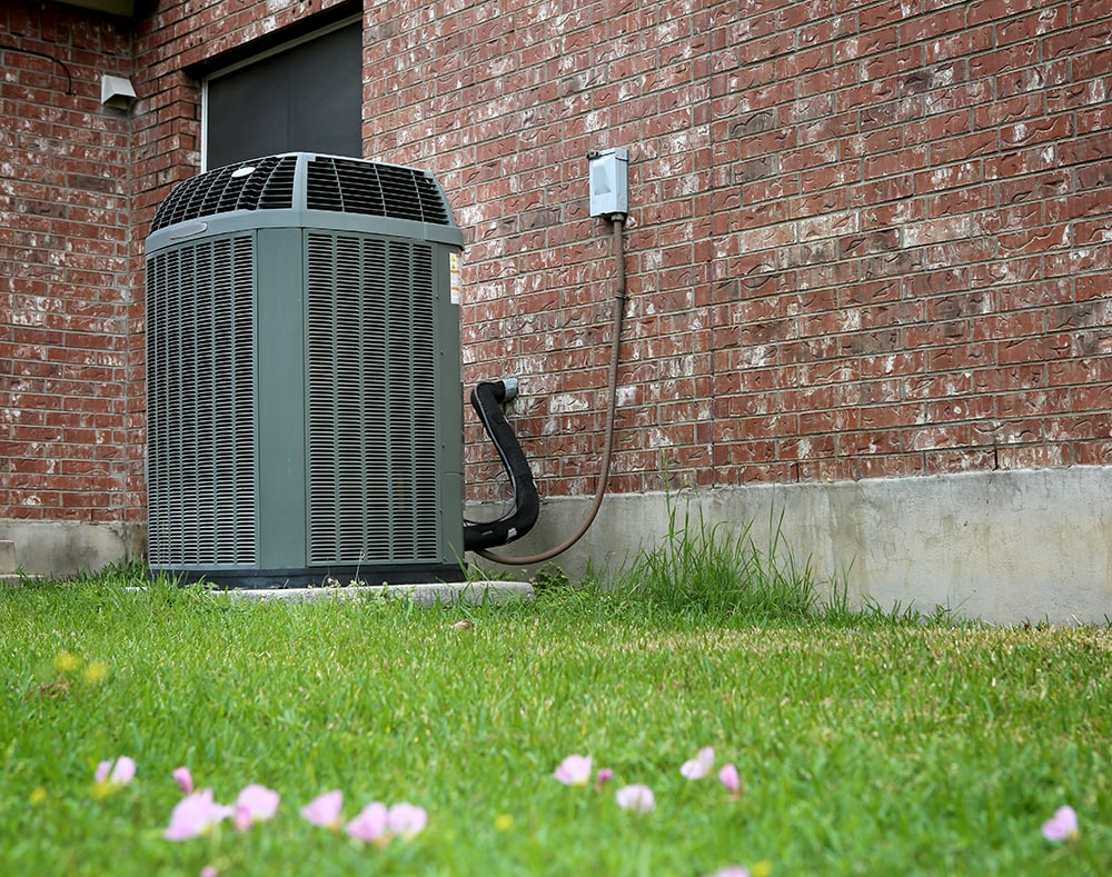High efficiency modern AC-heater unit on brick wall background.